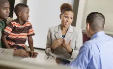 family including child attend a parent-teacher conference