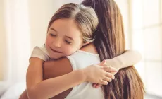 daughter hugs mother tightly