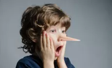 Boy in shock as his nose has grown like Pinocchio's