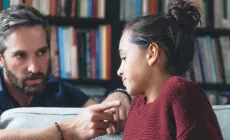 father and young teen daughter intense conversation